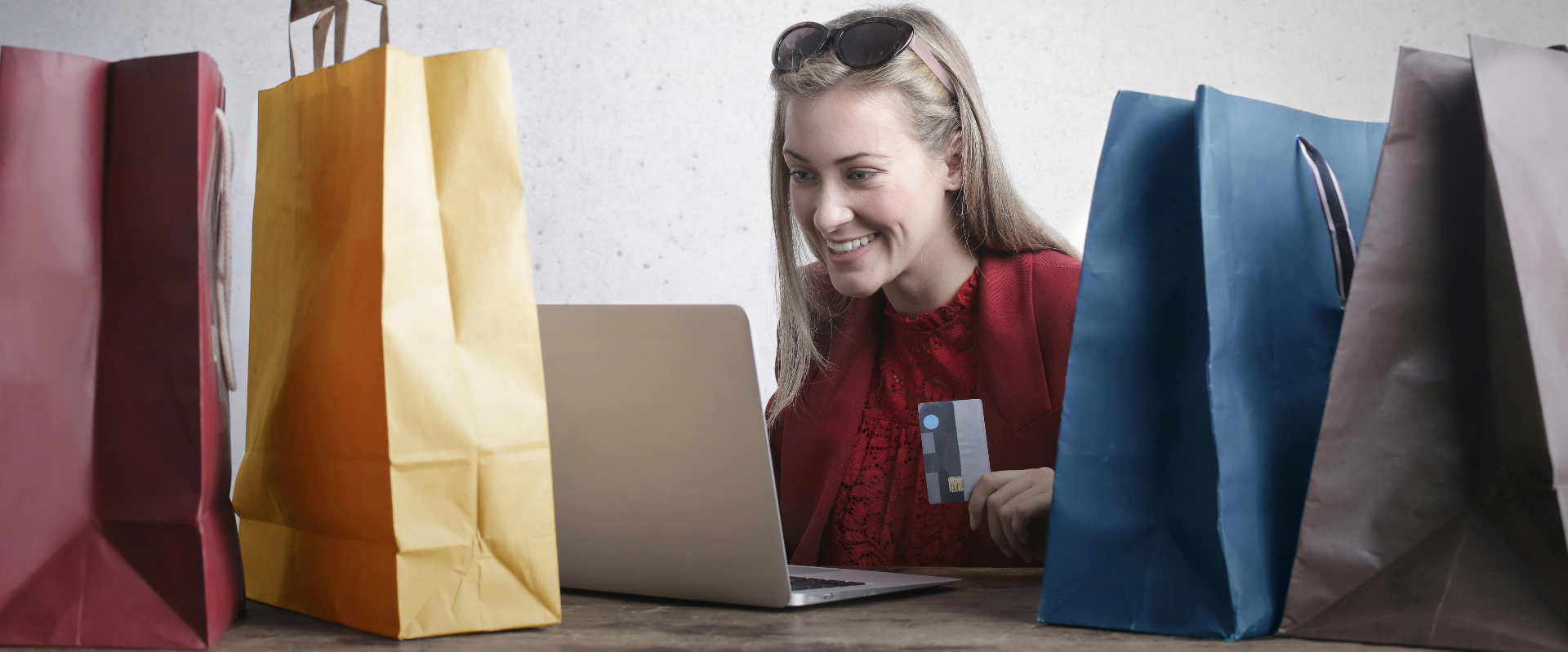 Person with shopping bags on laptop